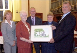 Betty Scroggy, pictured with her husband Tommy and the Rev Moreen Hutchinson, receives her gift of a painting of the Largy Church from Churchwardens Kate Magill and William Wright 